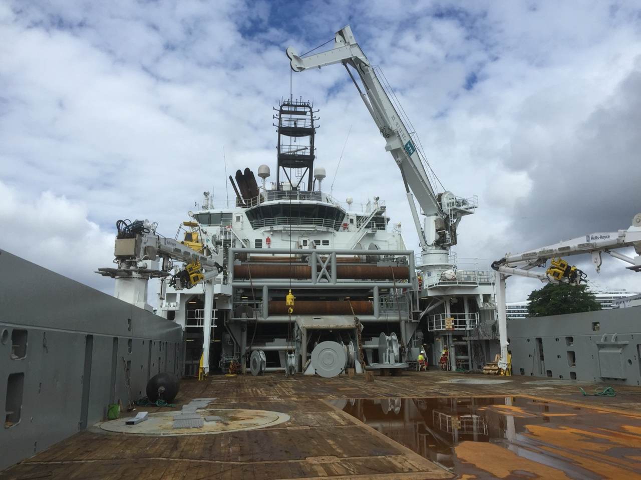 View along an open working deck towards the vessel superstructure.